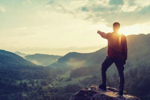 Explorer man looking at sunset Stock Photos