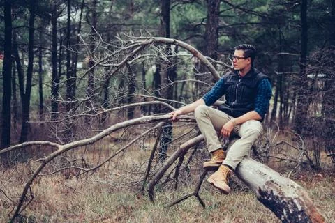 Explorer man resting on tree Stock Photos