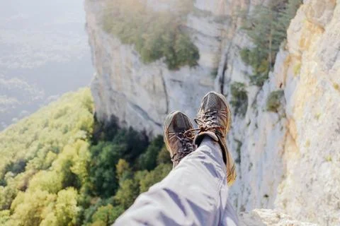 Explorer man sitting over valley, pov. Stock Photos