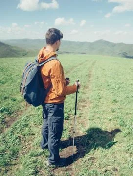 Explorer man walking in the mountains Stock Photos