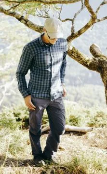 Explorer man walking in pine woods. Stock Photos