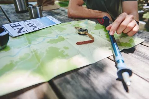 Explorer Preparing for Adventure with Map and Hiking Gear Outdoors Stock Photos