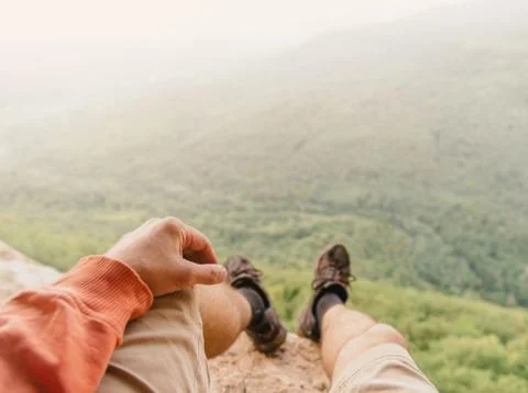 Explorer sitting in the mountains Stock Photos