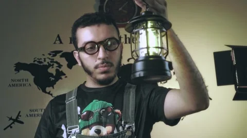 Explorer Vibes: Man Lifting Lantern Against World Map Stock Footage 318848214