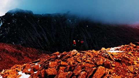 Explorers hike through misty terrain in the Pyrenees mountains of Spain Stock Footage 303624676