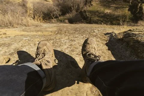 Explorers Rest: Dangling Boots Over a Georgian Cliff at Dusk Stock Photos