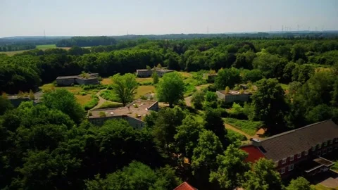 Exploring an abandoned area with overgrown buildings and quiet paths on a s.. Stock Footage 339782664