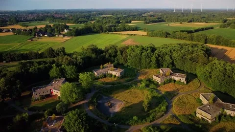 Exploring abandoned buildings in a rural area surrounded by fields and forest Stock Footage 339783197