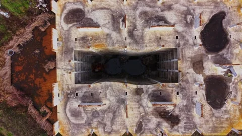 Exploring an abandoned structure from above in a green landscape Stock Footage 325086175