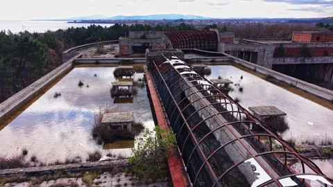 Exploring the abandoned structures near a serene waterfront Video stock 327143834