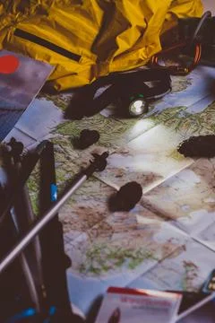 Exploring Adventure Hiking Concept. Looking navigation map in tent at night u Stock Photos