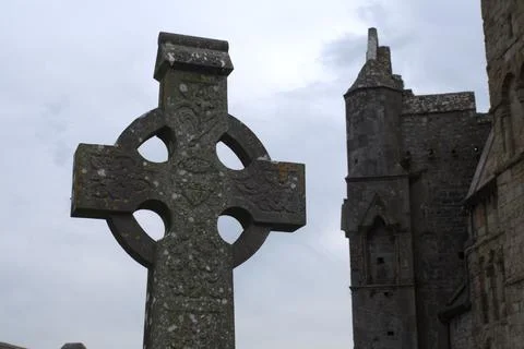 Exploring ancient celtic cross and medieval ruins of Rock of Cashel in Irel.. Stock Photos