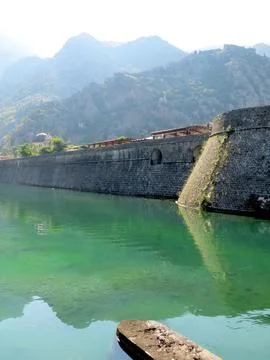 Exploring the Ancient Fortifications of Kotor Reflected in the Clear Waters.. Stock Photos