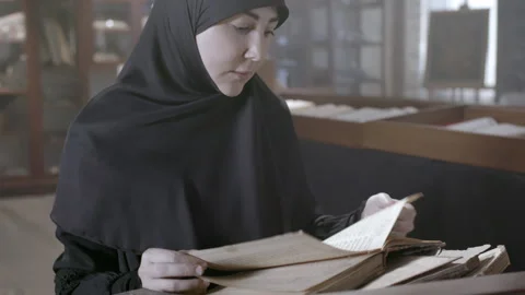 Exploring ancient manuscripts in a quiet library setting Stock Footage 318703756