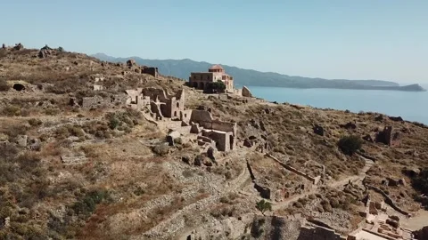 Exploring ancient ruins by the coast in a scenic landscape 库存影片 301735565