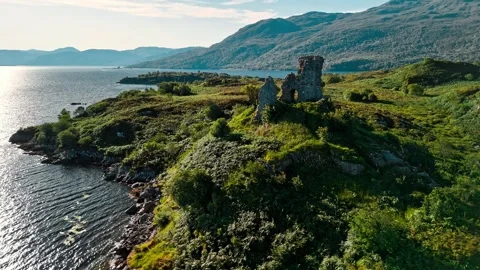 Exploring ancient ruins on a Scottish shoreline in the morning light Stock Footage 313999799