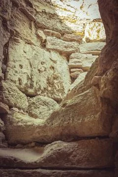 Exploring ancient stone structures in a rugged canyon during a bright afterno Stock Photos