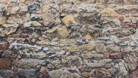 Exploring the Ancient Stone Wall Structure in a Historic Urban Setting Stock Footage 288360223
