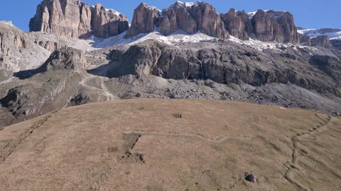 Exploring ancient structures on a vast hillside in a breathtaking mountainous Stockbeeldmateriaal 314081230