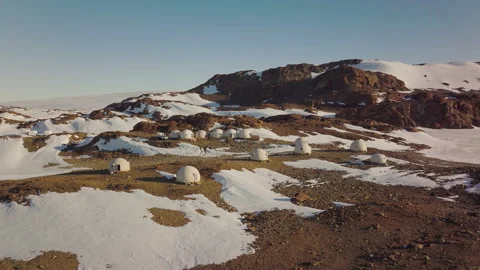 Exploring Antarctica Camp Base Science Station Surrounded by Snow and Rocky Stock Footage 288159642
