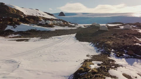 Exploring Antarctica Camp Base with Snow-Covered Landscape at Dusk Stock Footage 288157347