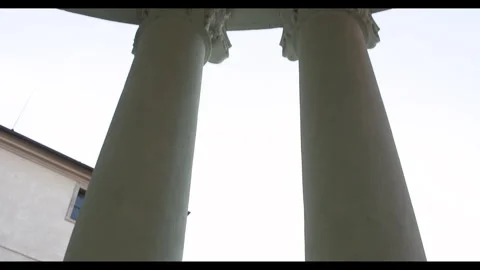 Exploring architectural details under a historic colonnade in a tranquil setting Video stock 283795460