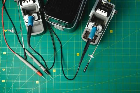 Exploring the art of electronics with tools and cables on a green mat Photos