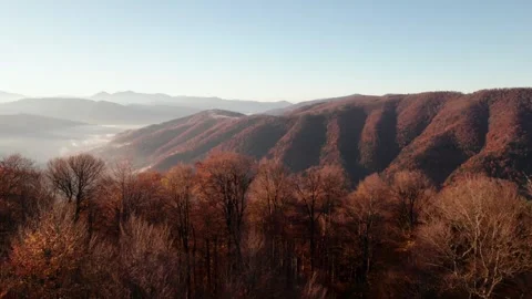 Exploring autumn mountains and valleys at sunrise 스톡 동영상 320265027