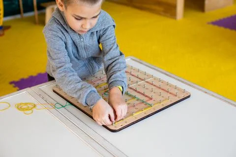 Exploring basic math and geometry concepts with geoboard Stock Photos