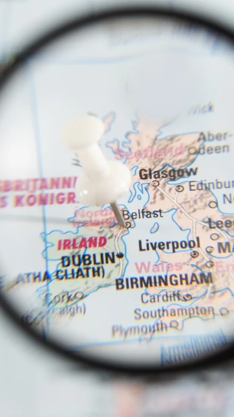 Exploring Belfast with a magnifying glass on a paper map Stock Footage 340078896