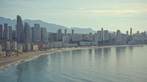 Exploring Benidorm's coastline with stunning views of its tall buildings and cle Stock Footage 337151936