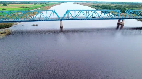 Exploring the blue bridge over the river in Latvia's scenic landscape Stock Footage 319549543