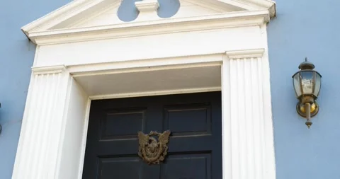 Exploring a Blue Building With a Black Door and a Light Stock Footage 262400876