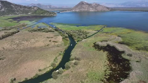 Exploring the breathtaking aerial view of Skadar Lake and its vibrant Stock Footage 287789776
