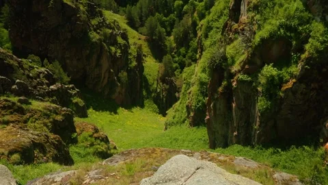 Exploring breathtaking cliffs and lush valleys in a serene natural landscape Video stock 313106364