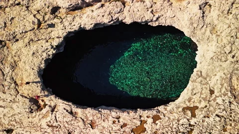 Exploring the breathtaking natural pool in Malta from above Stock Footage 306639764