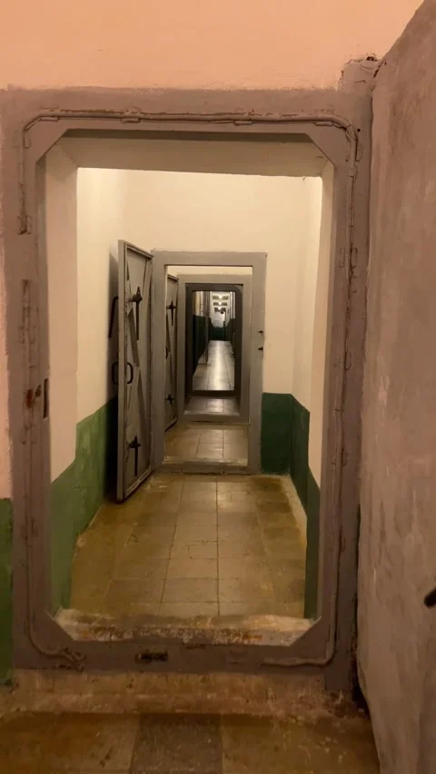Exploring Bunker Depths: First-Person POV through Heavy Doors Stock Footage 247580101