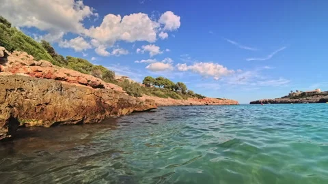 Exploring the calm, turquoise water of Cala Marsal in Portocolom Stock Footage 326231647