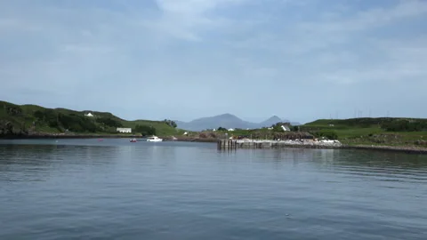 Exploring calm waters and distant hills in a scenic bay setting Stock Footage 325940414
