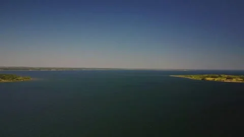 Exploring the calm waters of a large lake in the afternoon with a clear blu.. Stock Footage 339932370