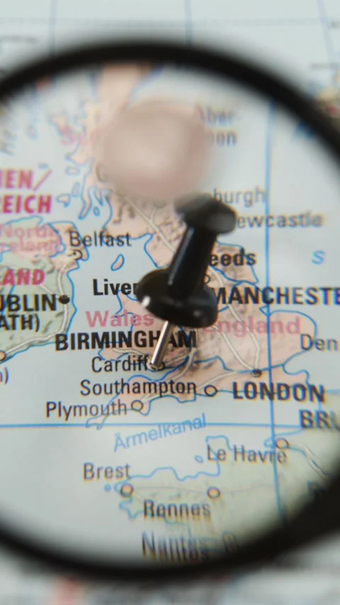 Exploring Cardiff on a paper map with a magnifying glass Stock Footage 340078965