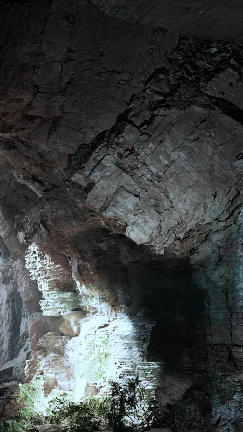Exploring a cave with rocks and light in a dark environment Stock Footage 335689727