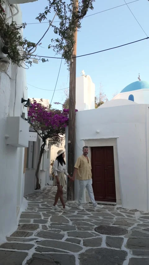 Exploring charming alleys of Paros Greece with vibrant flowers and beautiful Stock Footage 337372945