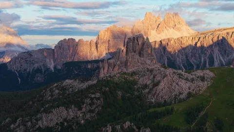 Exploring the Cinque Torri glowing at sunset in the Dolomites Stock Footage 314960024