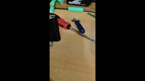 Exploring a circuit board wiring setup on a workbench at night with tools and pa 스톡 동영상 336128047