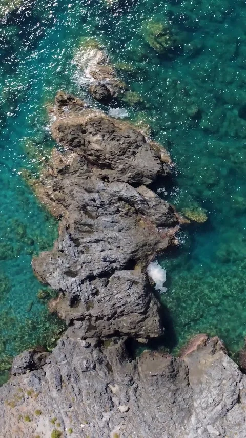 Exploring Clear Water and Rocky Coastline in a Coastal Area During Sunlight on a Stock Footage 330794467