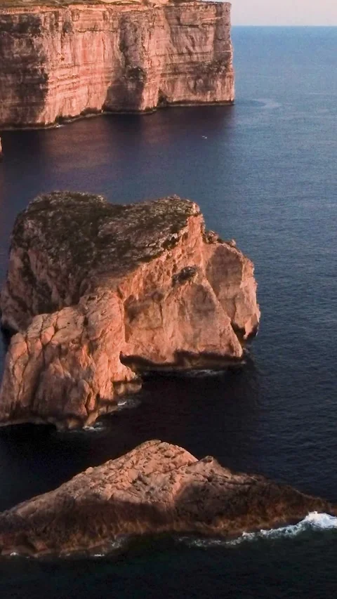 Exploring Cliffs and Rocks by the Sea at Sunset Near Coastlines. Gozo, Malta Stock Footage 334939022