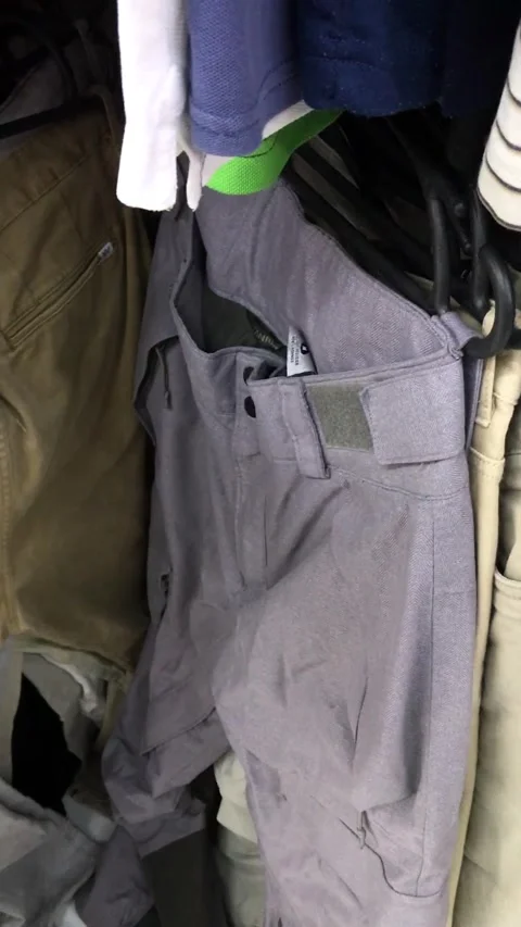 Exploring clothing options at a local thrift store Stock Footage 308368024