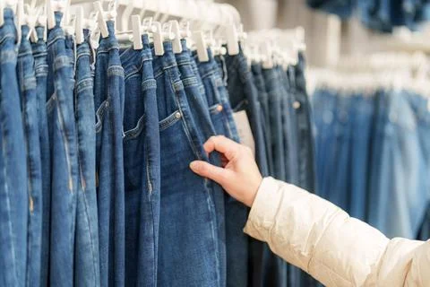 Exploring a clothing store in a mall while choosing denim jeans during a we.. Photos