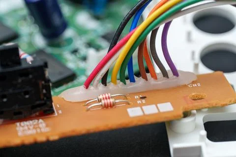 Exploring the colourful world within an old device motherboard where wires .. Stock Photos